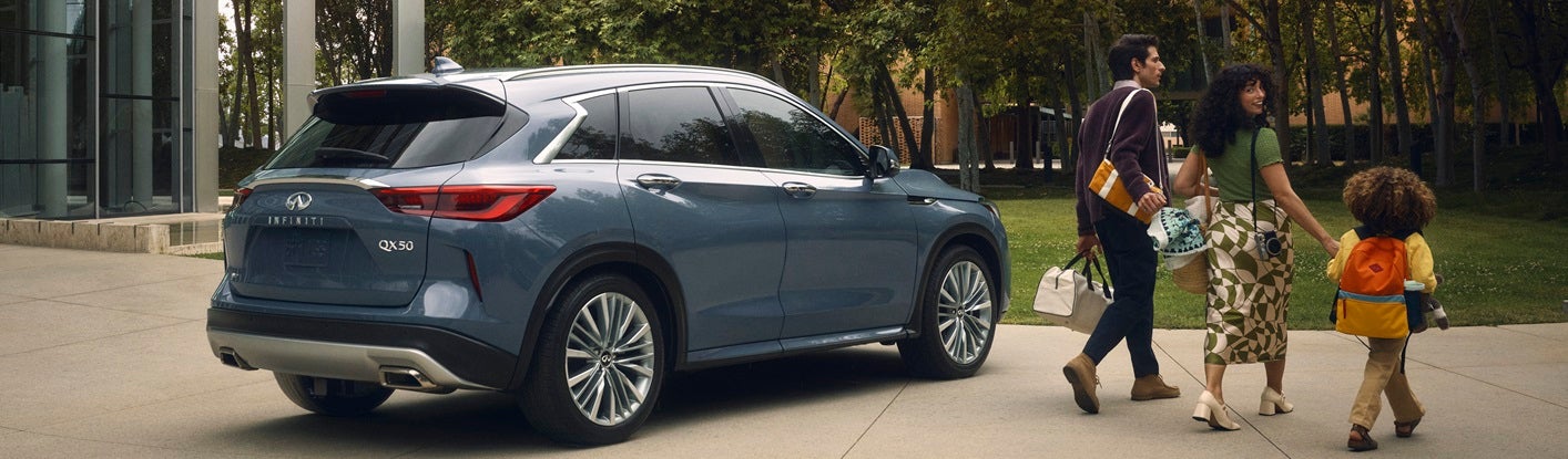 Family walking next to new INFINITI QX50