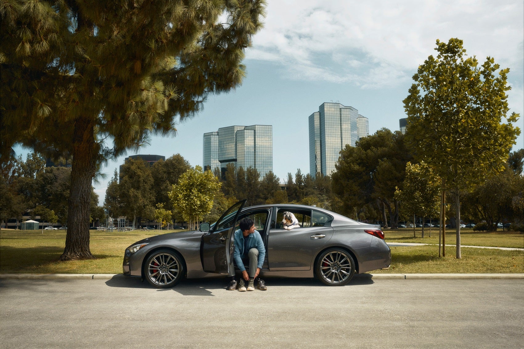 Man and dog in new INFINITI luxury vehicle