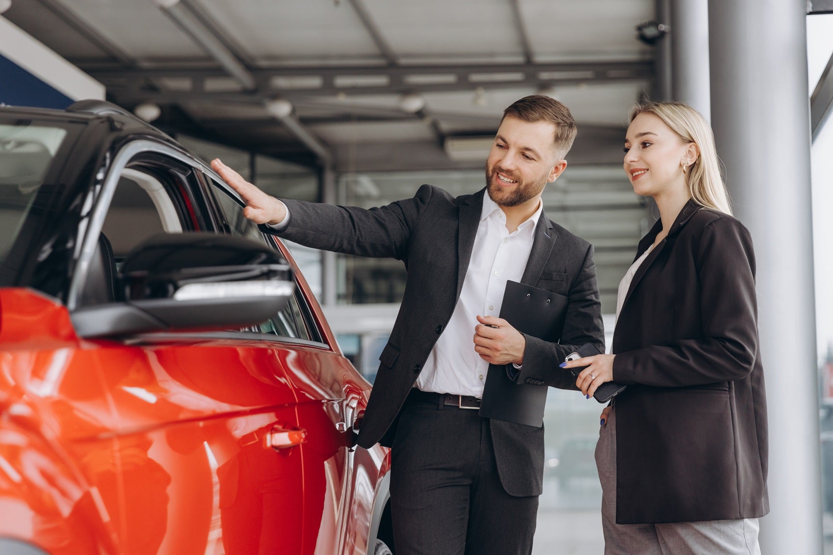 Salesperson Showing a Customer a Used Car