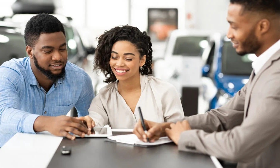 Couple Completing Financing for a Pre-Owned Vehicle