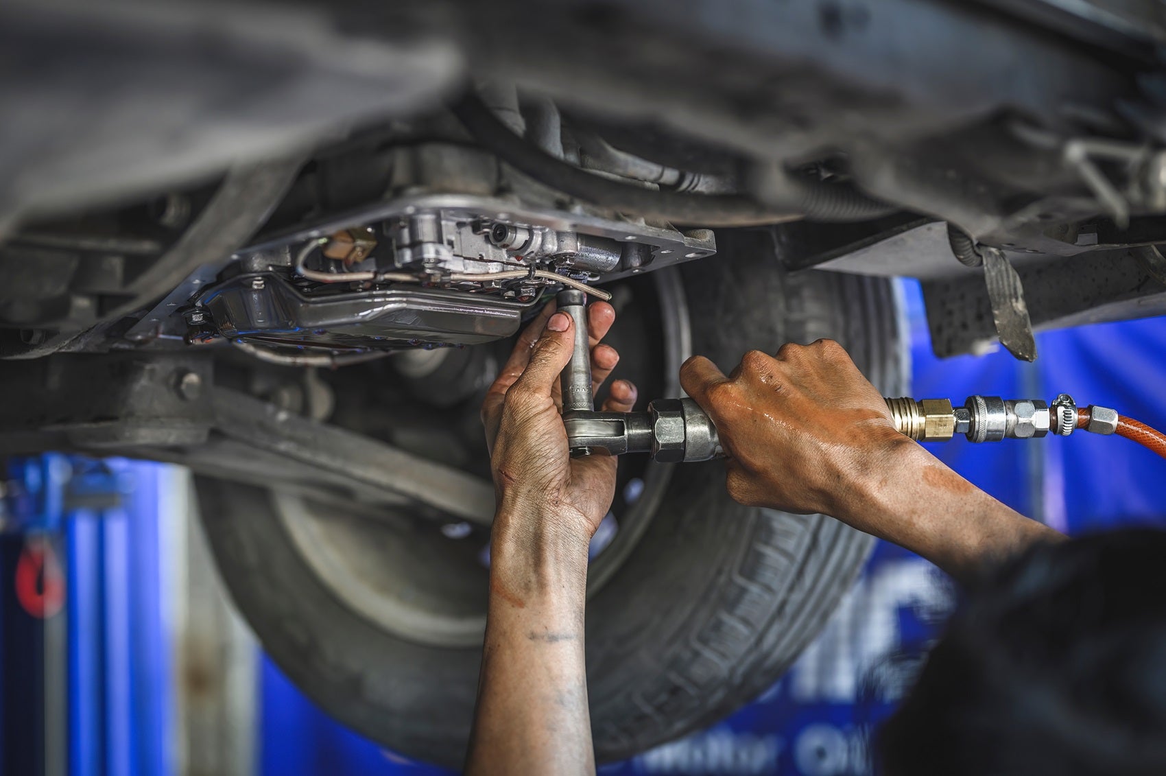 Service technician servicing an INFINITI vehicle