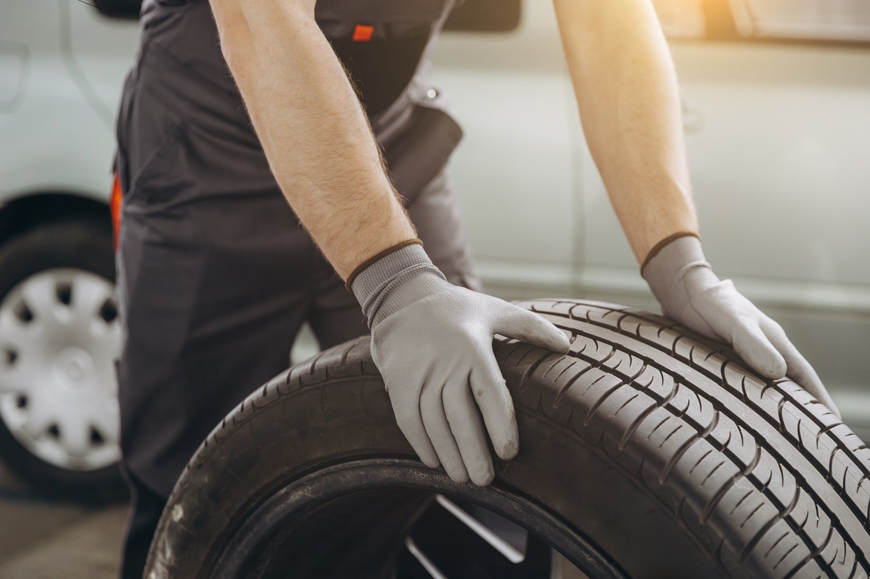 Service Technician moving tire for service